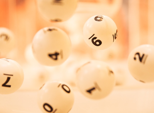 White, numbered lottery balls suspended in motion